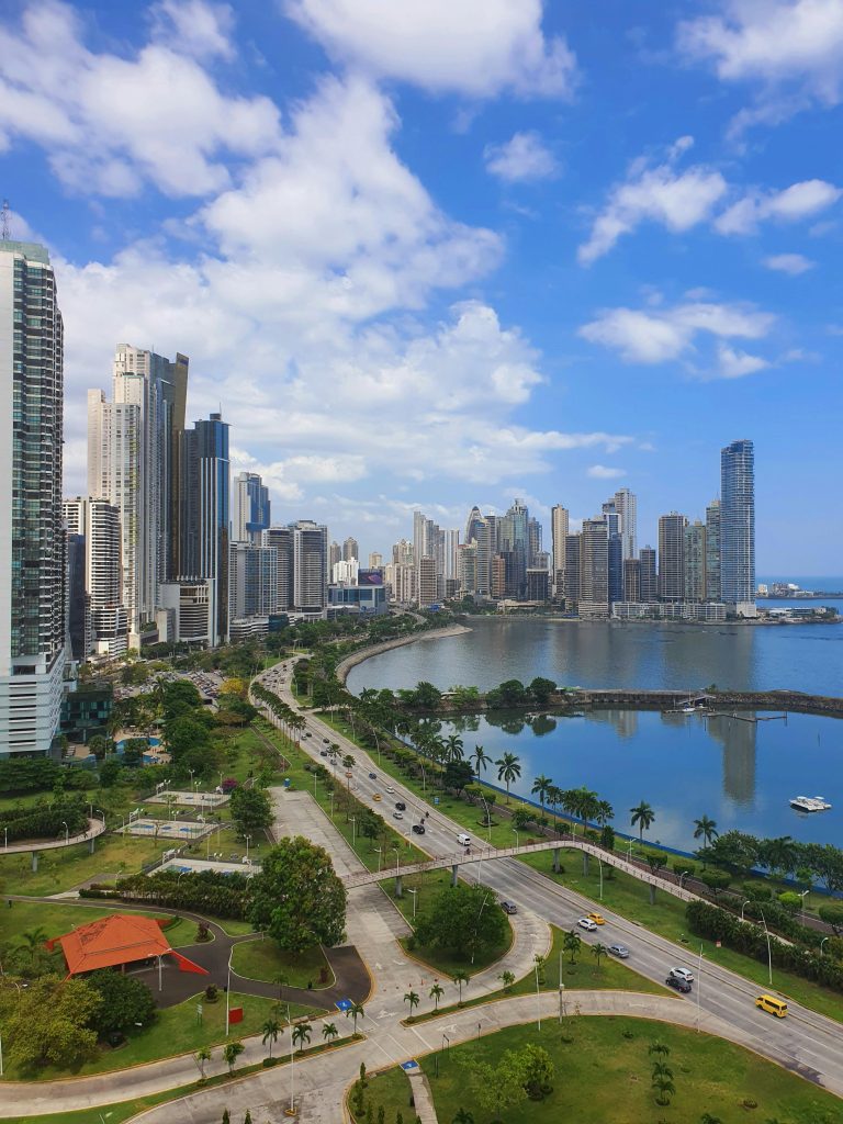 A breathtaking view of Panama City's modern skyline and oceanfront under a blue sky.